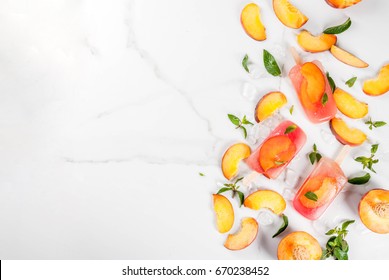 Summer desserts. Frozen drinks. Sweet fruit popsicles from frozen peach tea with mint. On a white marble table, with ingredients - peaches, mint, ice. Copy space top view