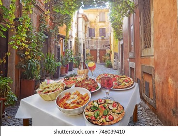 A Summer  Dinner .Pasta , Pizza  And Homemade Food Arrangement  In A Restaurant  Rome   .Tasty And Authentic Italian Food.