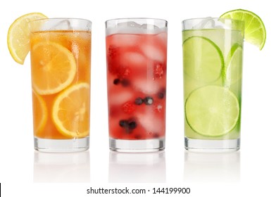Summer drinks with ice, fresh berries, lemon and lime isolated on white