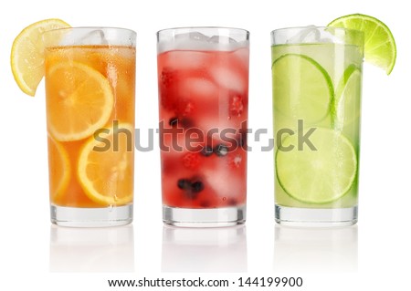 Summer drinks with ice, fresh berries, lemon and lime isolated on white