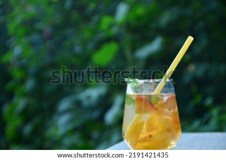 Summer drinks, with mint and peach cocktails with ice in glasses. Refreshing summer homemade Alcoholic or non-alcoholic cocktailsor Detox infused flavored water