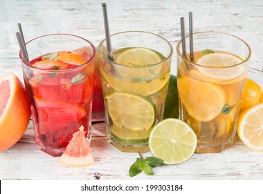 Summer Drinks On Wooden Table. Ice Tea With Fruits. 