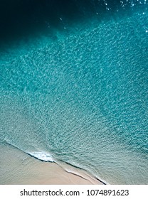Summer drone views of boat, waves, surfer and coastal towns