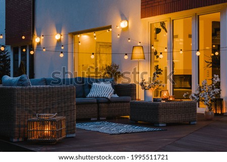 Summer evening on the patio of beautiful suburban house with garden