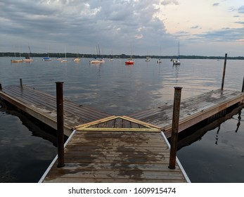 Summer Evening In White Bear Lake, MN. Dock Overlooking The Lake With Sailboats.