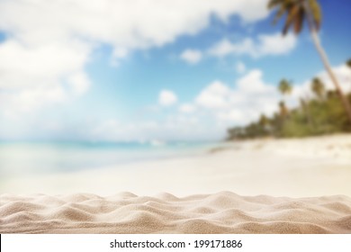 Summer Exotic Sandy Beach With Blur Palms And Sea On Background