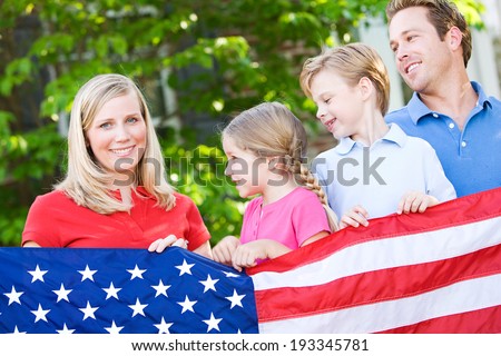Summer: Family Holding American Flag Looks At Mother