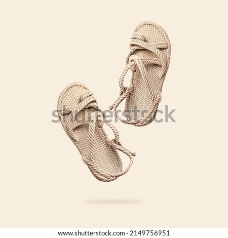 Summer female wicker sandals isolated on beige background. Fashionable trendy rope straw sandals. Jute slippers. Handmade Eco-friendly natural shoes. Cut out objects for design, Mock up