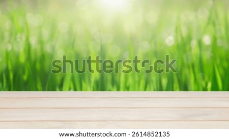 Summer field of wheat background. Empty wooden table top in front, blurred agriculture landscape background. Display product for Banner or advertise on social media,spring or summer concept