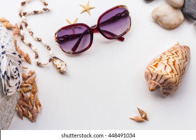 Summer Flat Lay Of Beach Set Items - Sea Shells, Star, Sunglasses, Stones, Necklace And Panama Hat, On Clean White Background. For Tourism, Holiday And Travel Image With Selective Focus