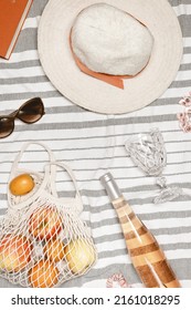 Summer Flat Lay With Rose Wine, Wine Glass, Fruits In Bag, Sun Hat, Sunglasses, Book For Reading On Beach Towel As Background. Summer Beach Party And Rest Concept. Relaxation At Summertime. Top View