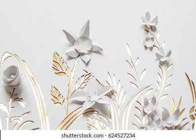 Summer flowering meadow. White flowers carved from paper on a white and gold background. Cut of paper