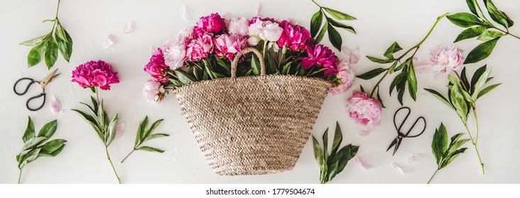 Summer Flowers Layout. Flat-lay Of Pink And Purple Peony Flowers In Basket Over Plain White Background, Top View. Florist Shop Website Banner Or Wallpaper