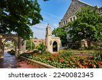 Summer flowers surround Sample Gates at Bloomington Indiana University entrance