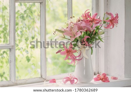 summer flowers in vase on white windowsill