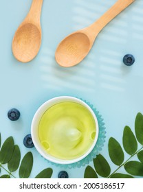 Summer, Food Composition With Natural, Vegan Ice Cream, Blueberries, Leaves And Wooden Spoons On A Blue Background. Eco Friendly Still Life With Fruit, Frozen Yogurt. Healthy, Tasty Snack. Flat Lay