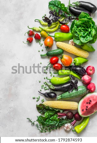 Summer fresh organic vegetables fruits harvest background. Organic garden vegetables, berries, fruit on a light background, top view                       