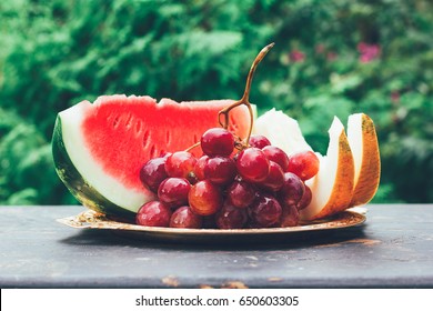 Summer Fruit Berry Still Life With Slices Of Watermelon, Melon And Grape Bunch On The Table