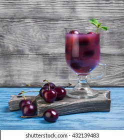 Summer Fruit Cocktail With Fresh Sweet Cherries, Black Cherry Berries For Fruit Cocktail, Mint, Glass, Board On Blue Wooden Background In Rustic Style