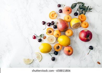 Summer Fruits Assorted On White Marble Background. Fresh Raw Food Concept. Copy Space