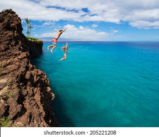 Summer fun, Friends cliff jumping into the ocean. 