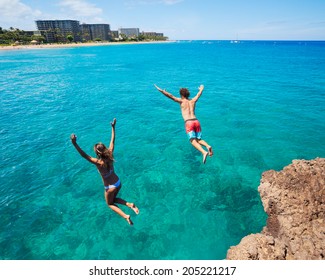 Summer Fun, Friends Cliff Jumping Into The Ocean. 