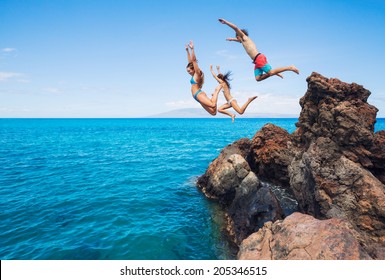 Summer fun, Friends cliff jumping into the ocean. 