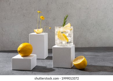 Summer gin tonic cocktail on the white podium. Hard seltzer cocktail with lemon. - Shutterstock ID 1999013372