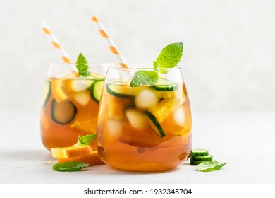 Summer Green Tea Cucumber Orange Mocktail In Glasses. Space For Text.