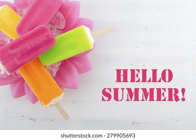 Summer is Here concept with bright color ice pop, ice creams with Hello Summer text. 