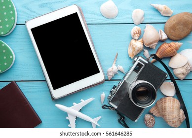 Summer Holiday Background, Travel Concept With Tablet And Camera On Wooden Table Background