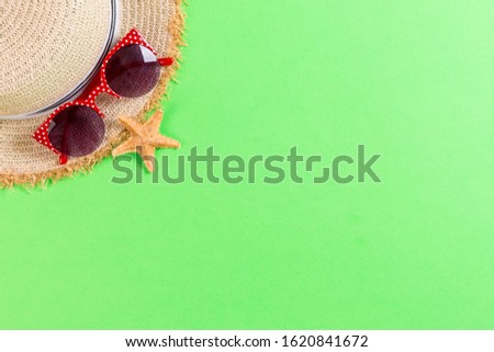 summer holiday beach background with accessories on green table, top view with copy space. vacation concept.
