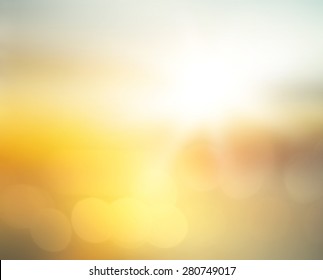 Summer holiday concept: sun light   abstract blur yellow morning sunrise beach background