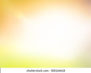Summer holiday concept: Sun light and abstract blur soft yellow and orange nature background