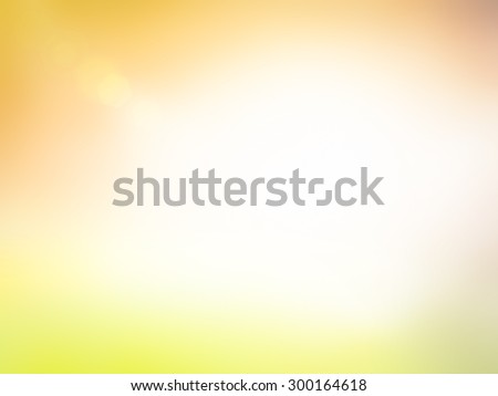Summer holiday concept: Sun light and abstract blur soft yellow and orange nature background