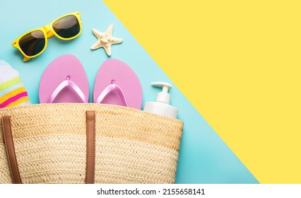 Summer holiday concept.Top view of beach bag with flip flops,beach towel,sunglasses,sunscreen and starfish with space for text over yellow and blue background

 - Powered by Shutterstock