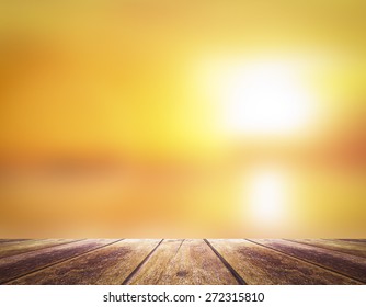 Summer Holiday Concept: Wooden Table Border With Blurry Beautiful Sunlight And Golden Sunset Background