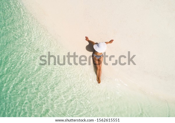 Summer Holiday Fashion Concept Tanning Girl Wearing Sun Hat At The Beach On A White Sand Shot