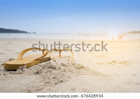 Summer holiday on the beach yellow sandals on the beach have sunset