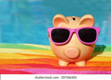 Summer Holiday Piggy Bank With Sunglasses In Front Of A Swimming Pool