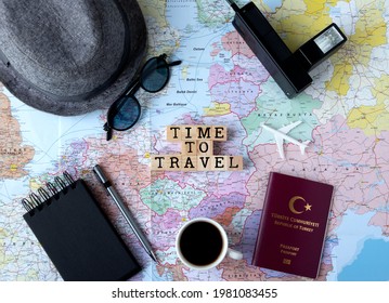 Summer Holiday Planning , Traveler’s Accessories, Turkish Passport, Model Airplane, Block Note, Pen, Sunglasses, Hat, Photo Machine And A Cup Of Coffee On World Map. Summer Holiday Background