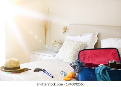 Summer Holiday Travel Accessories Prepared On The Bed And Mask For Holiday Travel In Coronavirus Season In Bedroom. Vacation Travel Concept. Top View.