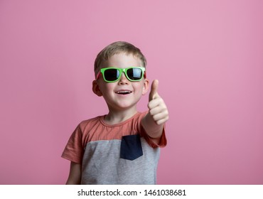 Summer holiday and vacation concept. Happy stylish school boy in sunglasses with thumb up against pink background. Back to school  - Powered by Shutterstock