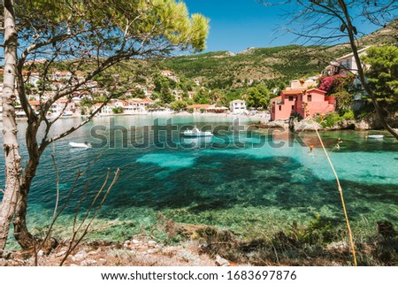 Summer holiday vacation in Greece. Transparent mediterranean cove and small town Assos. Kefalonia Greece