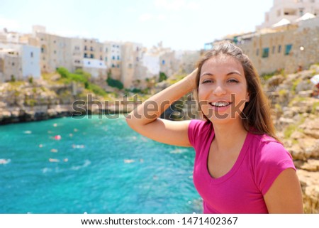 Summer holidays in Apulia. Portrait of beautiful girl in Polignano a mare town, Italy