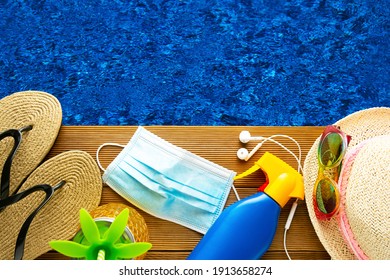 Summer Holidays, Beach Accesories Over Wooden Plank With Face Medical Mask And Blue Water Swimming Pool, Top View.