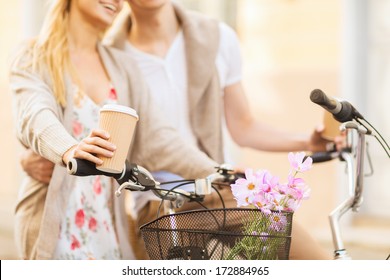 Summer Holidays, Bikes, Love, Relationship And Dating Concept - Closeup Of Couple Holding Coffee And Riding Bicycle