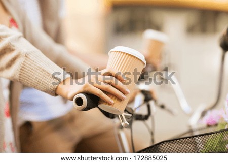 Similar – Image, Stock Photo Hand holding coffee, woman drinking in background