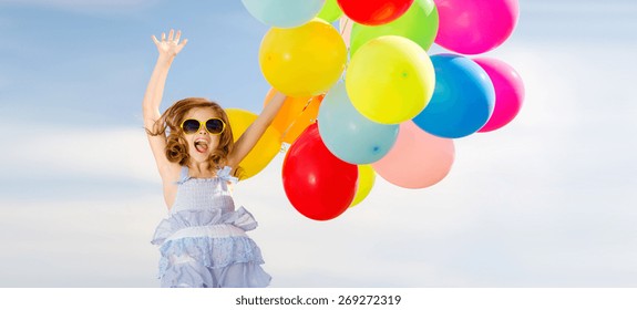 Summer Holidays, Celebration, Children And People Concept - Happy Jumping Girl With Colorful Balloons Outdoors