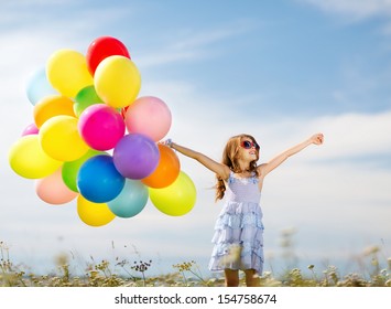 summer holidays, celebration, family, children and people concept - happy girl with colorful balloons - Powered by Shutterstock